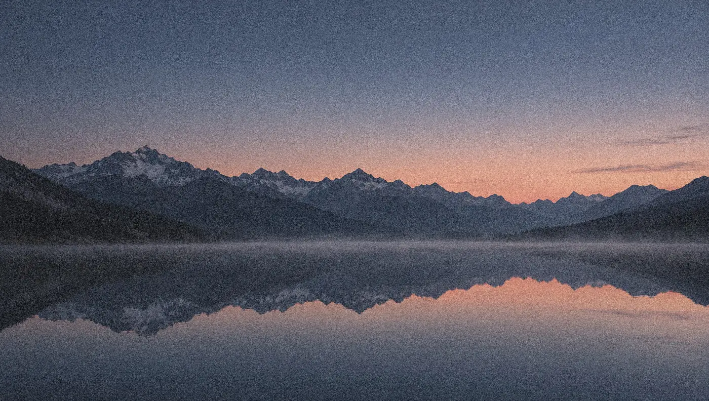 A mountain range reflected in a still lake