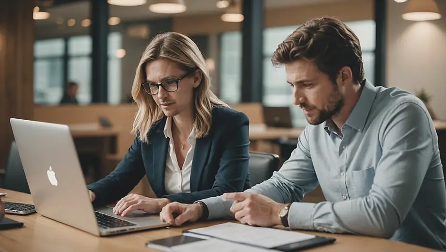 A customer and a finance professional engage in a discussion on-site, reviewing financial documents and analyzing data on a laptop.
